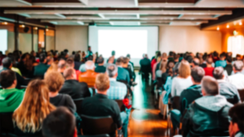 An out of focused image of an audience at a conference