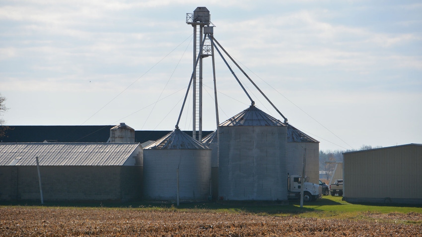 Grain bins near a barn