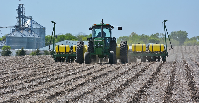 John Deere tractor and planter in field John Deere tractor and planter in field