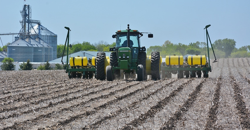 John Deere tractor and planter in field