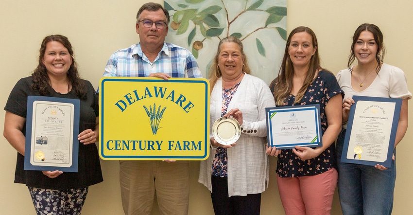 Beth Johnson, Stanley Johnson, Linda Johnson, Tammy Osborne and Krista Johnson holding Delaware Century Farm sign