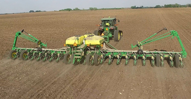 Large-scale machinery planting soybeans on a farm in Iowa – captured using a drone