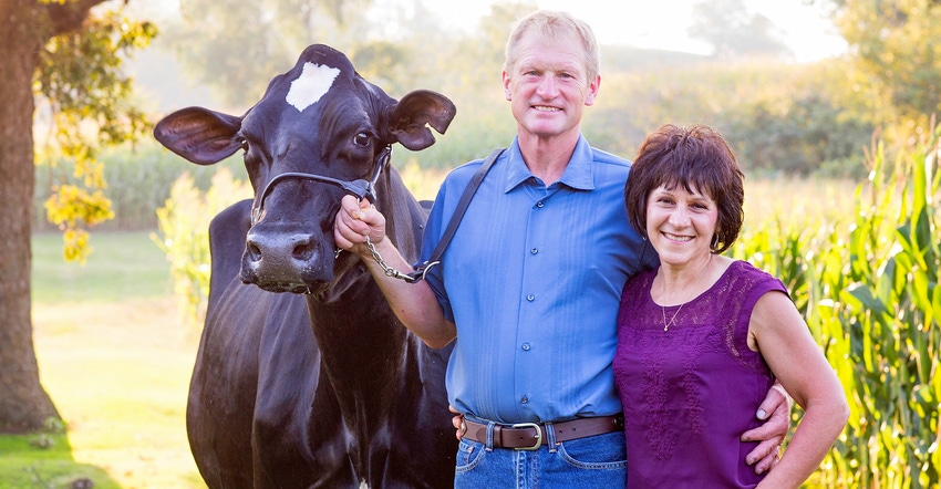 2020 Master Agriculturist Jeff Hendrickson and his wife Kate with a homebred Holstein cow 