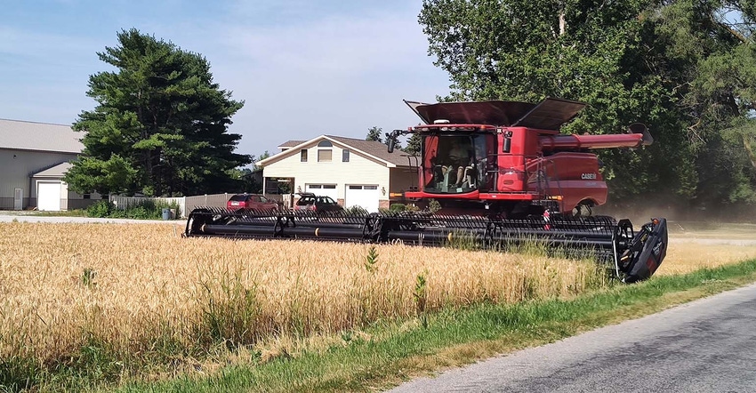 Combine ready to harvest wheat field