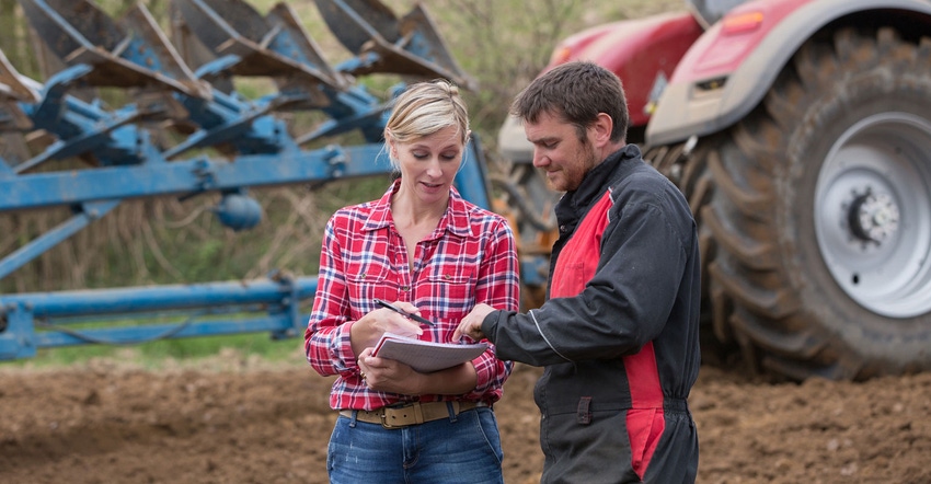 Farm operators converse in the field