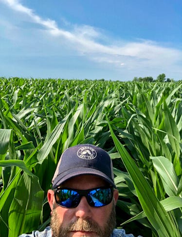 Drew Haines, who farms in Middletown, Md., takes a selfie from between lush rows of summer corn