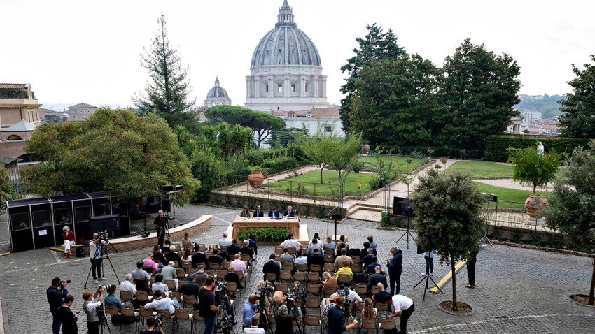 People gather in gardens outside the Vatican