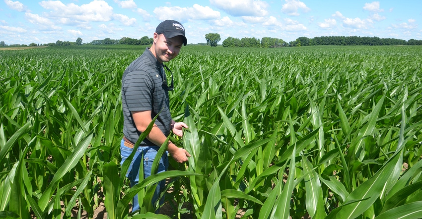 Dan Quinn standing in cornfield