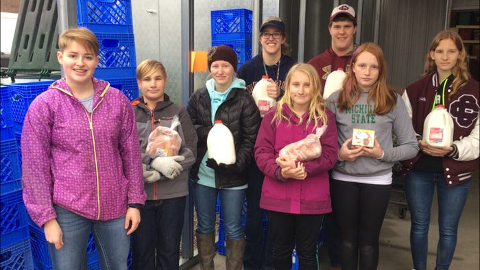 Addy Stuever Battel and other young volunteers at a food pantry