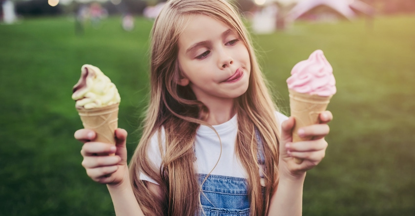 Little girl holding ice cream cones