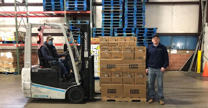 Herbruck’s employees Frank Labine and Chris Miller load eggs from the processing facility into a truck