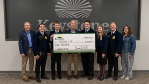Keystone Cooperative CEO Kevin Still presents a check donation to Indiana FFA state officers