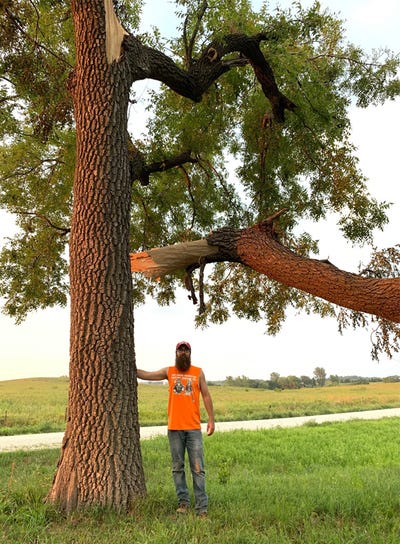 Billy Beck standing next to tree