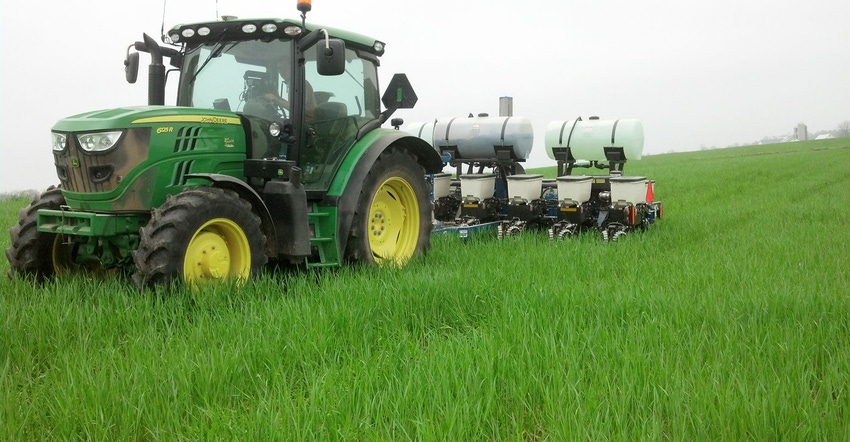 Tractor seeding into lush green cover crop