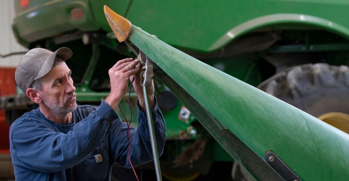 Person working on combine head