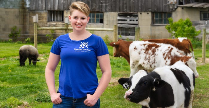 Addy Battel posing with cows 
