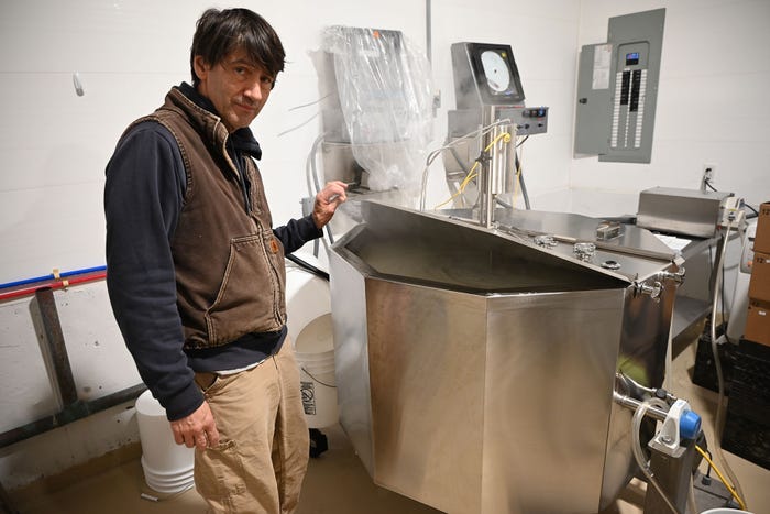 Mark Lopez opens a vat pasteurizing machine 