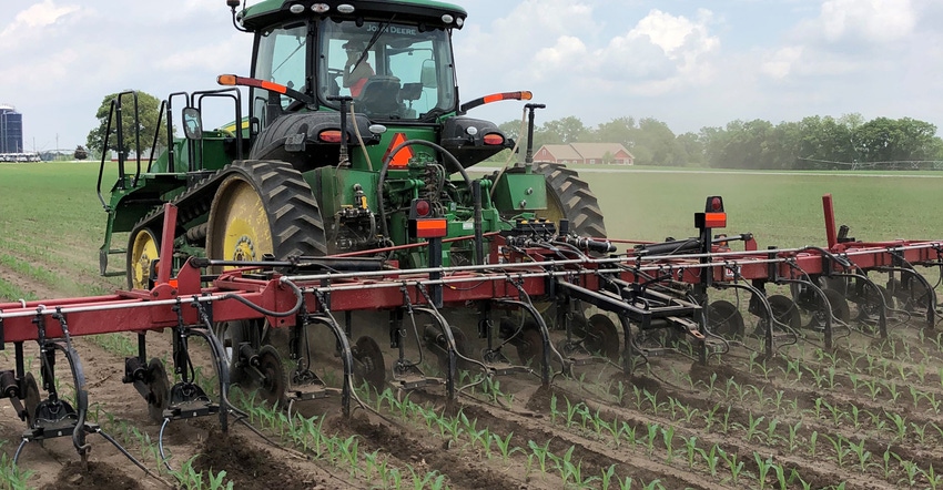 tractor applying nitrogen in cornfield
