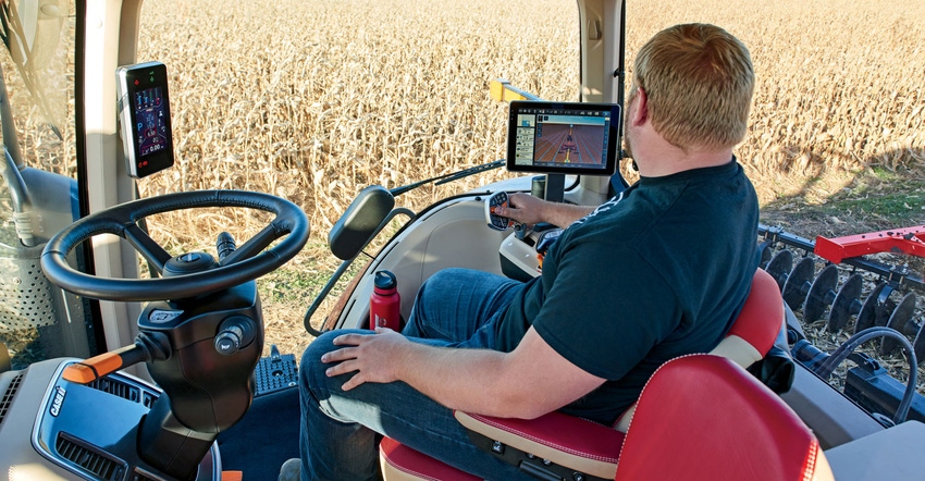 A farmer uses the AFS Connect Farm app while harvesting corn