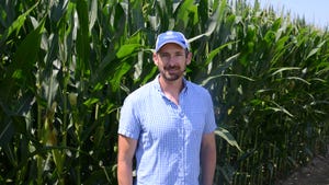 Mark Jeschke stands in front of test corn seed plot