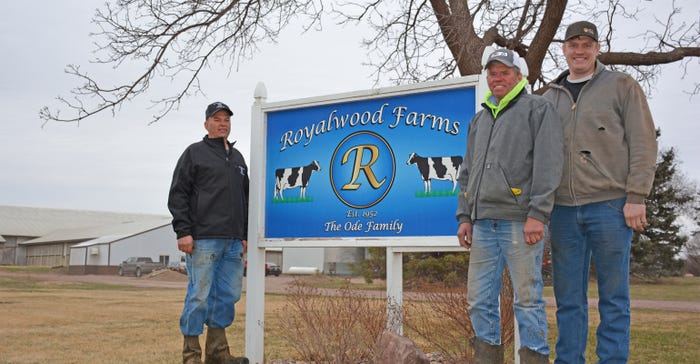The Ode's standing next to Royalwood Farms sign