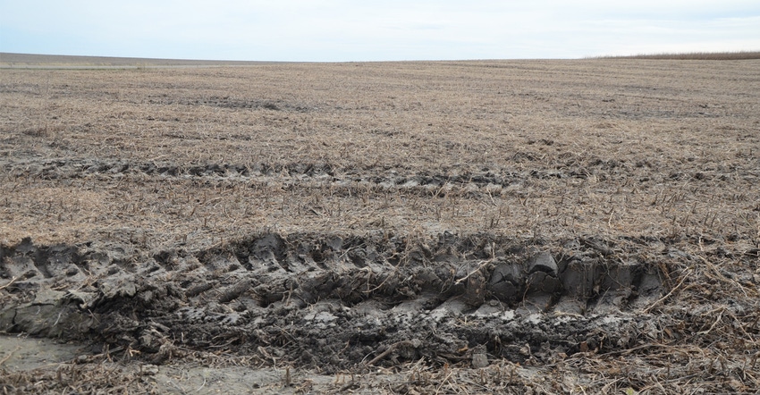 Closeup of tractor tracks in dirt in field