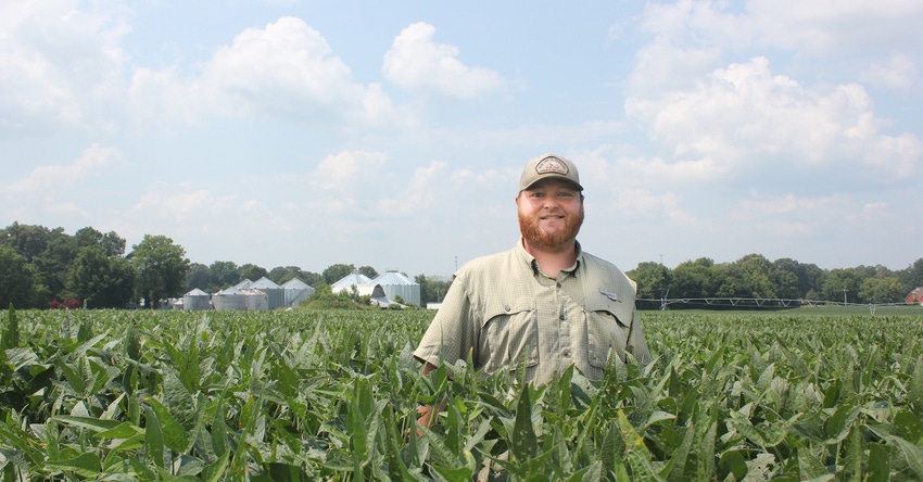 Robert Allen King stands in soybean field