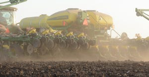 corn planter in dusty field