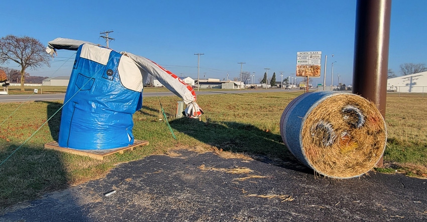 man made of round hay bales that lost its head man made of round hay bales that lost its head