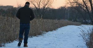 farmer walking on snowy path