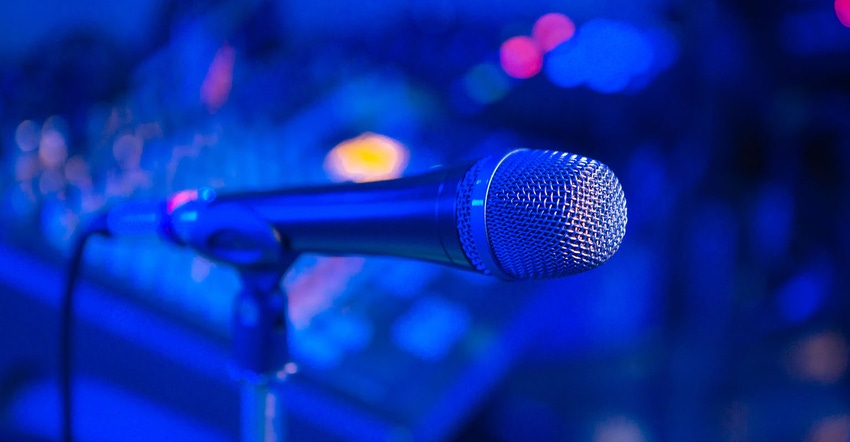 Microphone on the blurred background of the audio mixer of a musician.