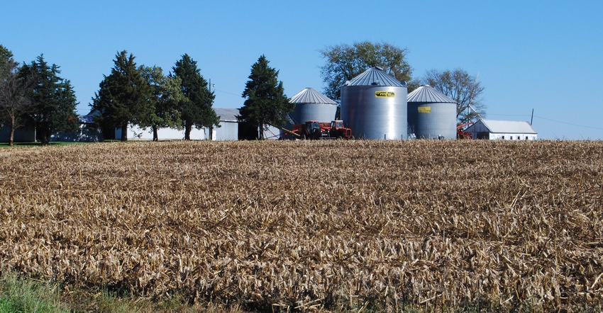 winter cornfield with grain bins in the backgournd