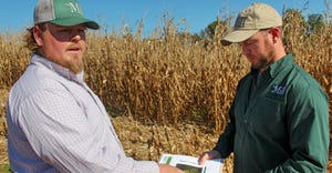 Mike Kurek and his crop adviser Tim Hushon evaluate plots
