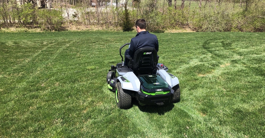 man riding all-electric riding lawnmower