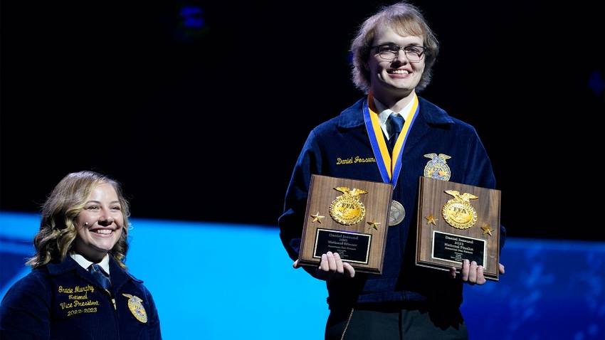 Daniel Jossund holding two plaques he won at the National FFA Convention