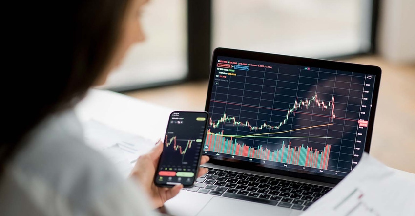 woman analyzes market chart on laptop and phone woman analyzes market chart on laptop and phone