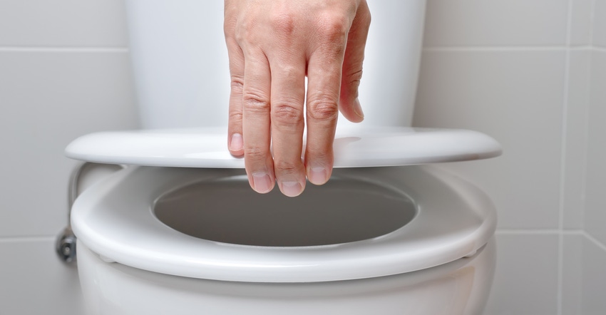 hand of a man closing the lid of a toilet hand of a man closing the lid of a toilet