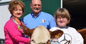 Susan and Terry Hayhurst with young girl and cow