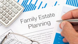 Family estate planning document,  calculator, hand holding pen