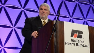 Bernie Engel, Purdue agriculture dean, stands behind a podium