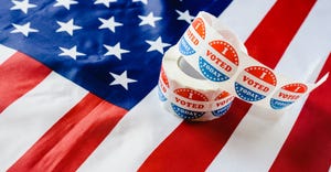 roll of "I Voted Today" stickers on top of American flag