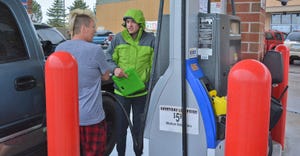 Chris Daniels talks about fuel options with customer at gas pump