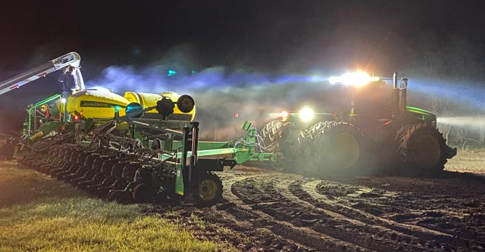 Tractors working late at night on a field