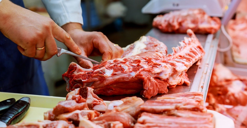 Butcher processing meat Butcher processing meat