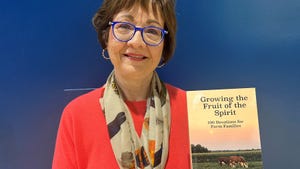 Susan Hayhurst holding a copy of the book she co-authored