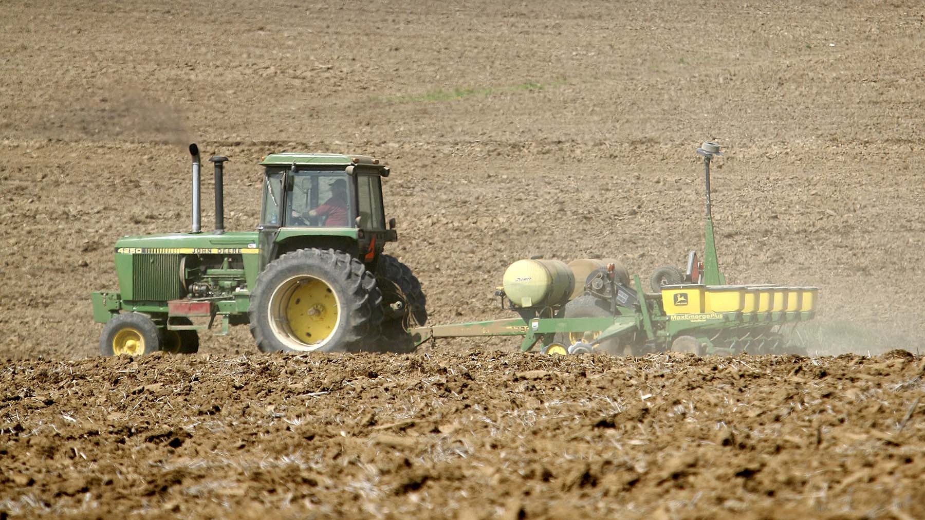 John Deere tractor and corn planter in Iowa field