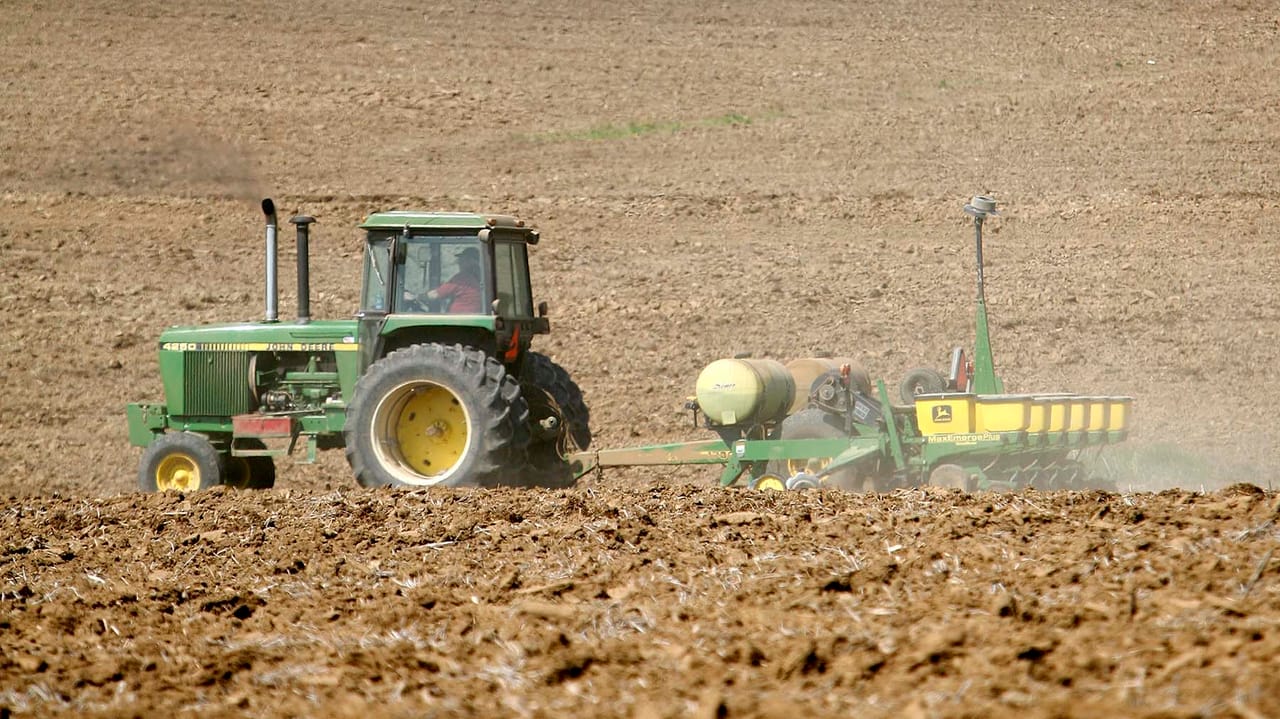 John Deere tractor and corn planter in Iowa field