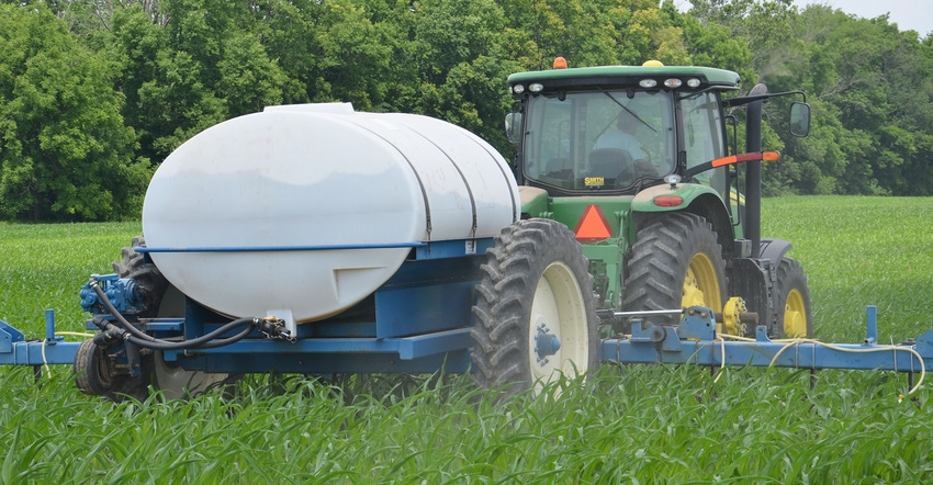 tractor applying nitrogen in cornfield