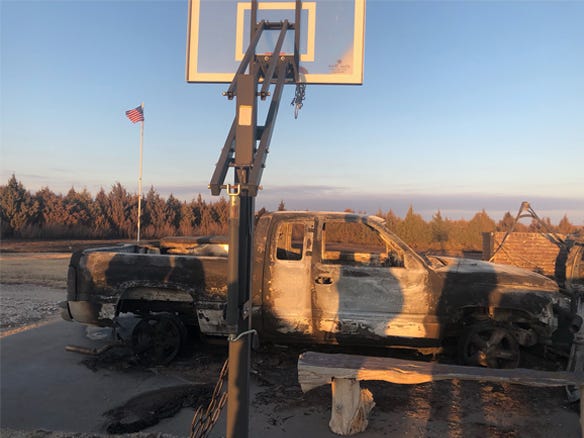 A burned pickup truck sits in the midst of the Four-County Wildfire zone. 