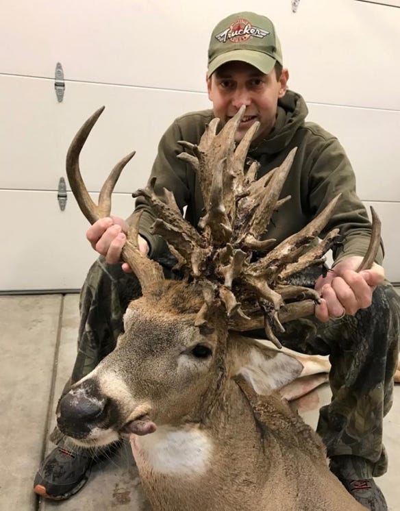 Brian Butcher is pictured with the non-typical whitetail buck he harvested with a bow and arrow in Chase County last October